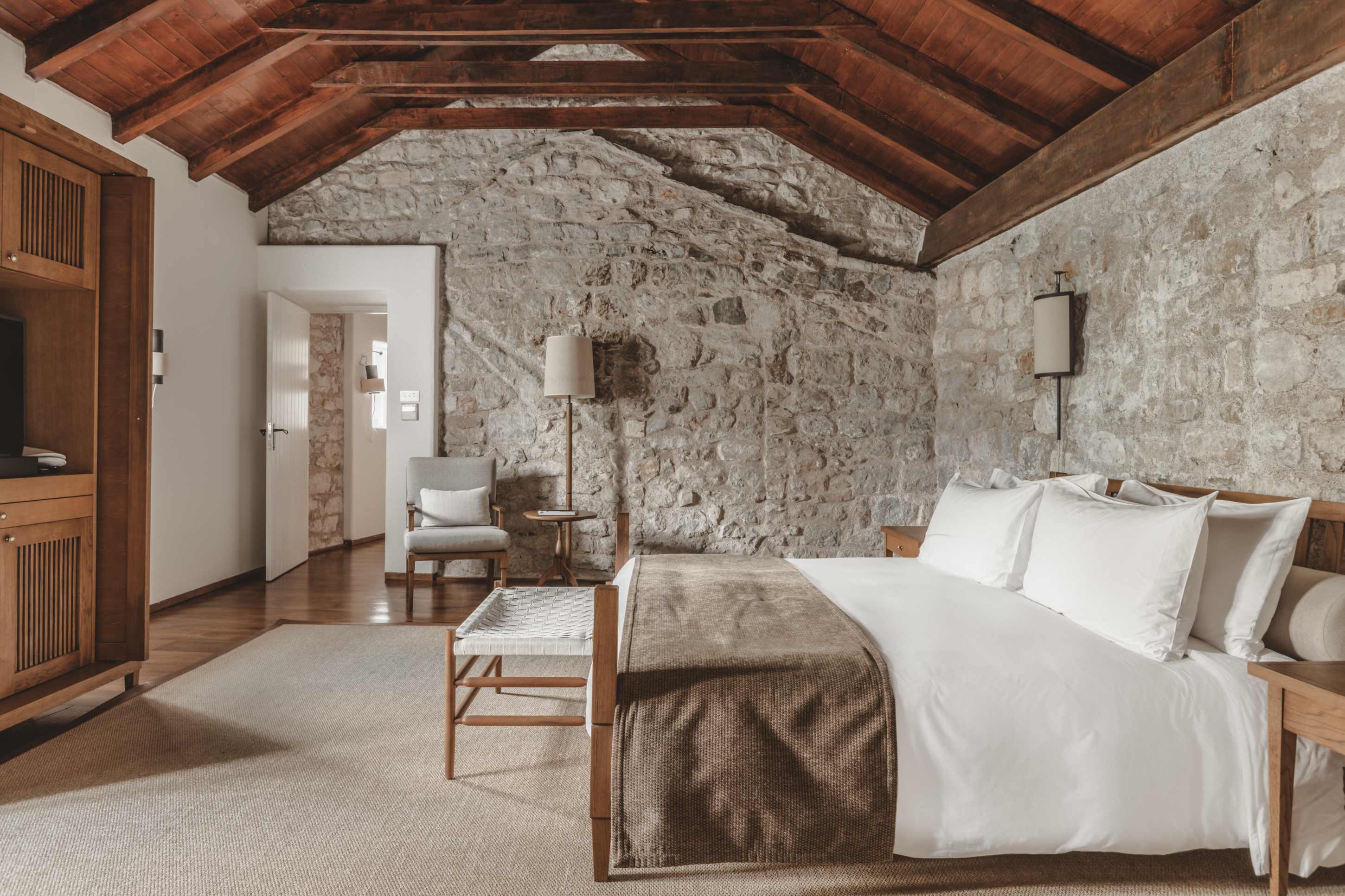 Aman Sveti Stefan Montenegro &ndash; Two-Bedroom Suite Master Bedroom, Natursteinwand, warmes Licht | nova-reisen