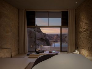 Schlafzimmer mit modernem Design und Blick auf die Felsen – exklusives Wüstenresort