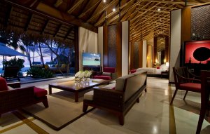 grossräumiges wohnzimmer mit blick auf die private terrasse und den pool auf den malediven im one & only reethi rah