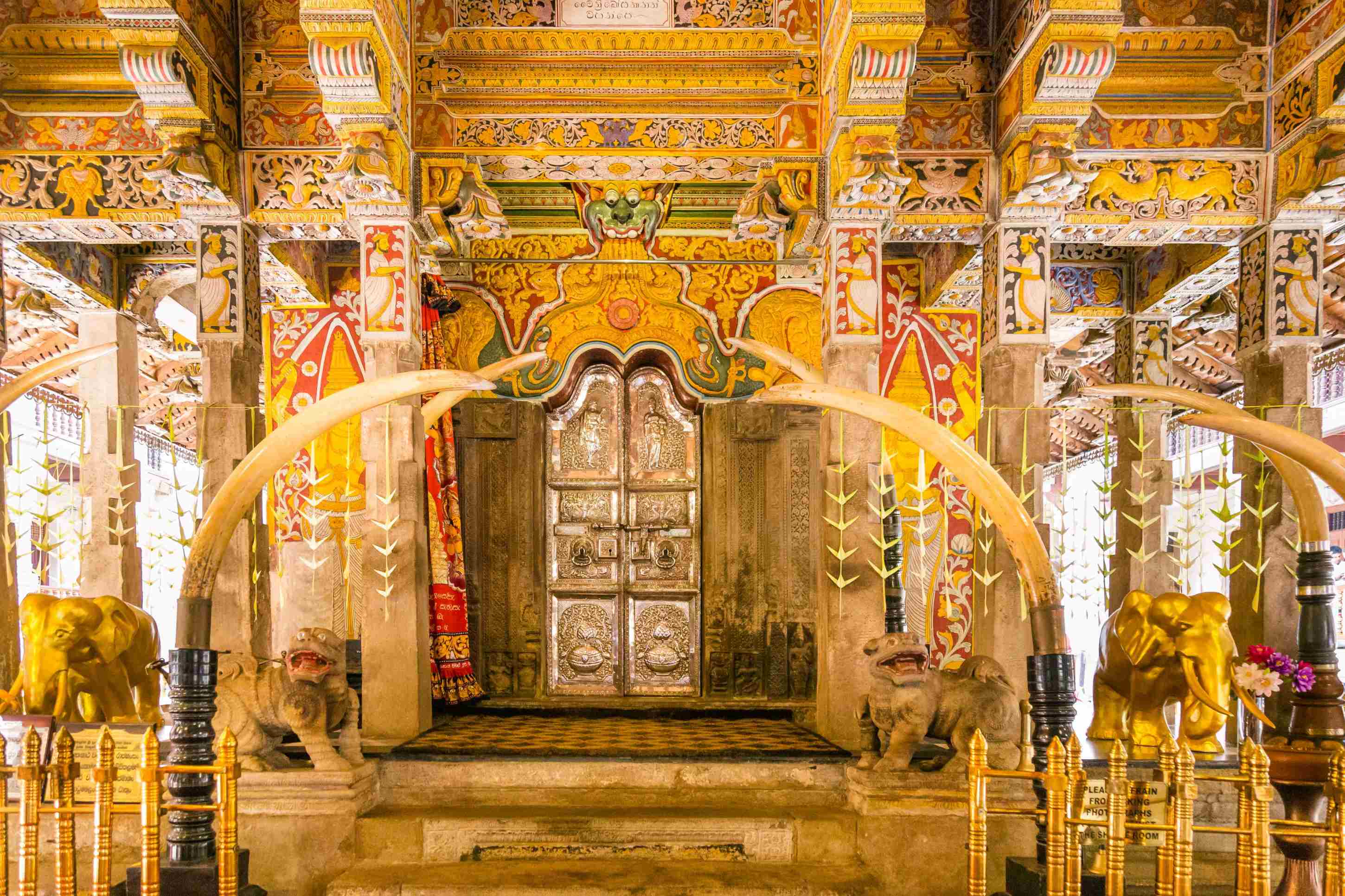 Blick in einen prachtvolle Tempel mit Buddhas Zahn umgeben von viel Gold und Figuren bei hellem Licht auf Sri Lanka